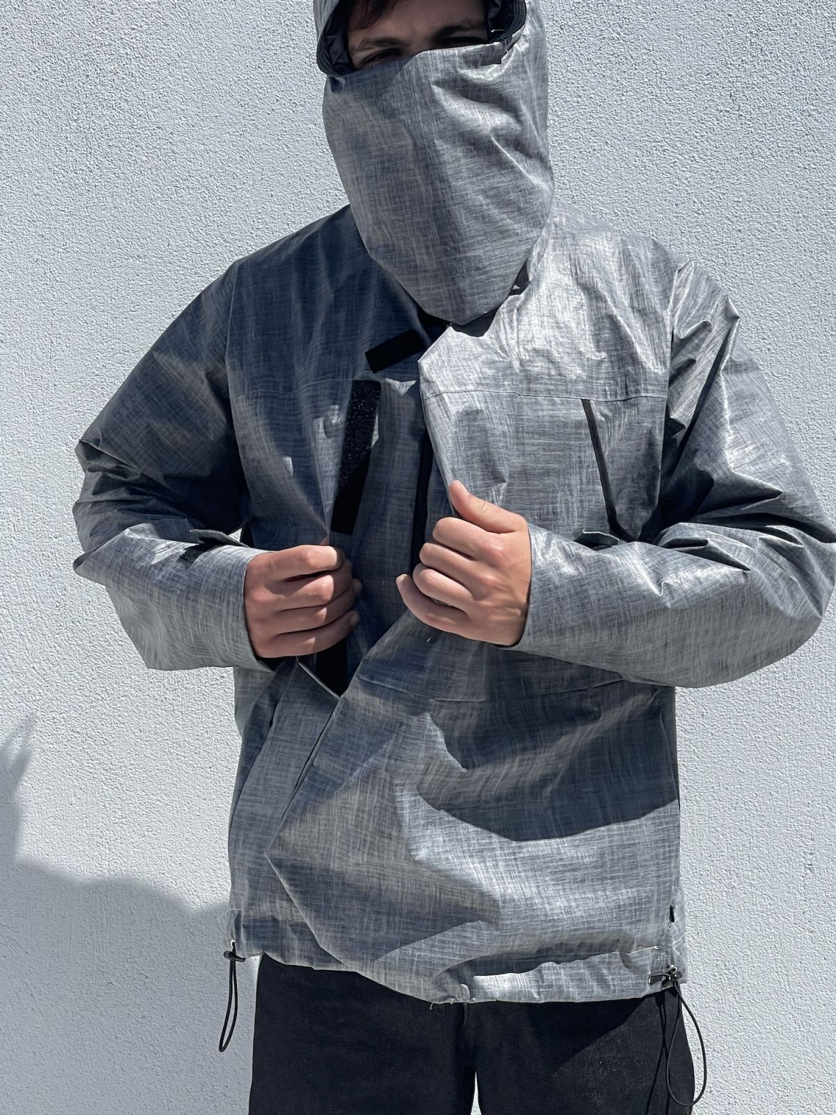 Waterproof jacket front view with pull of velcro front section