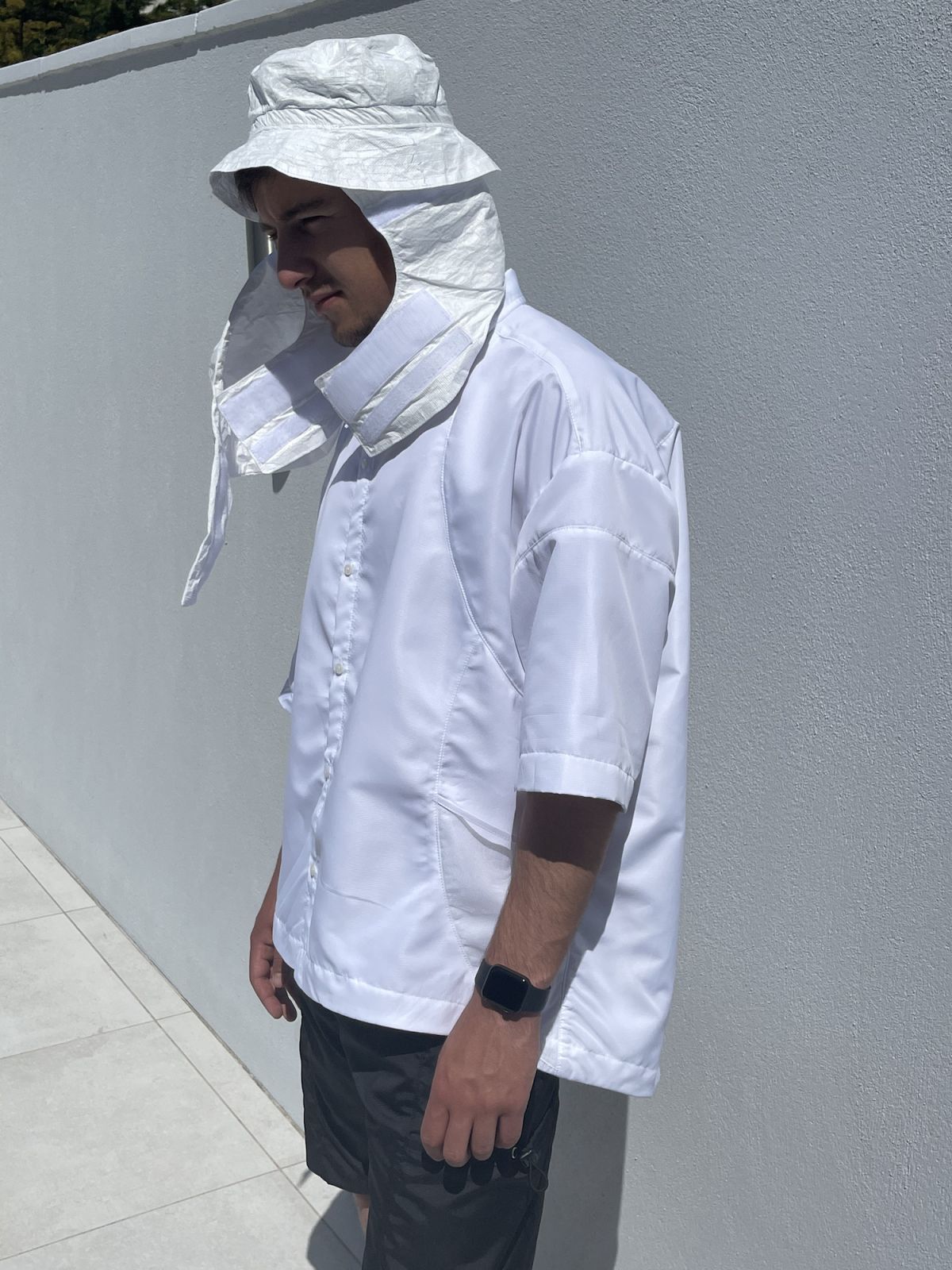 Polyester shirt side view and bucket hat hood