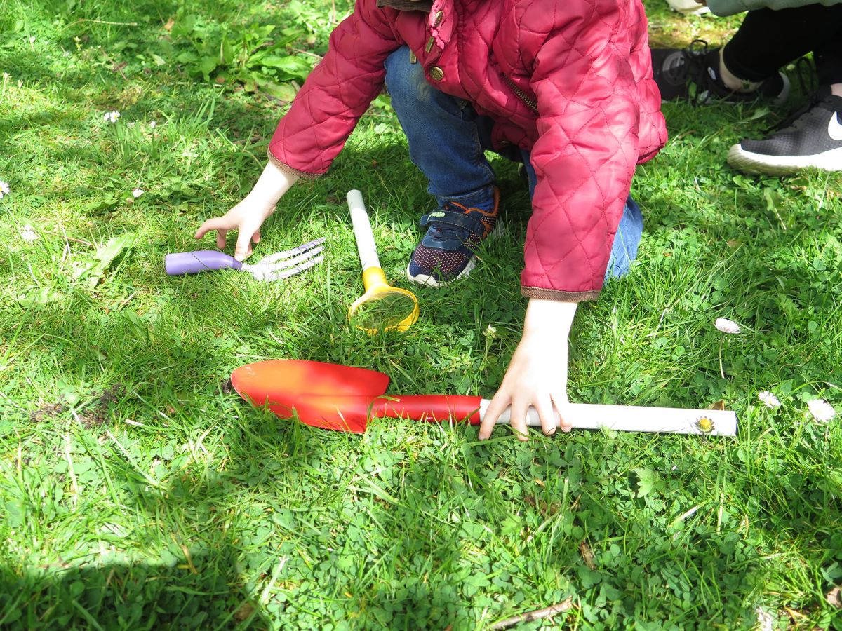Combo tools being used by a parent and child in a forest and meadow