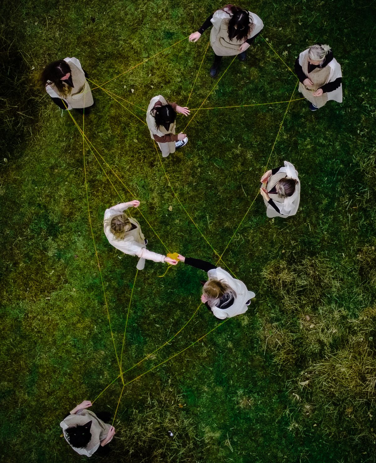 Performative actions at the Curragh. A family of women weave themselves together using wool