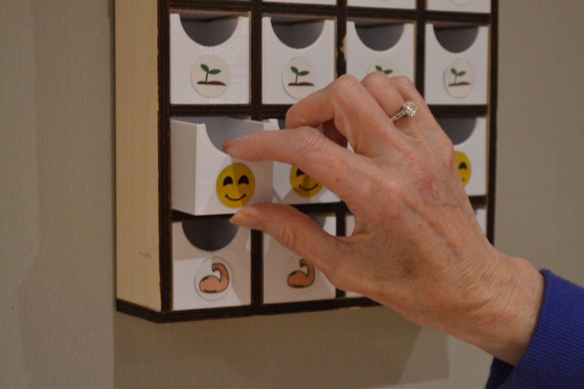 Teacher interacting with badge storage unit