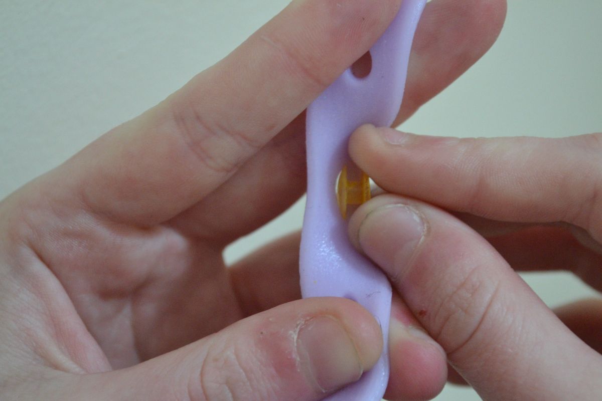 User applying badge to bracelet