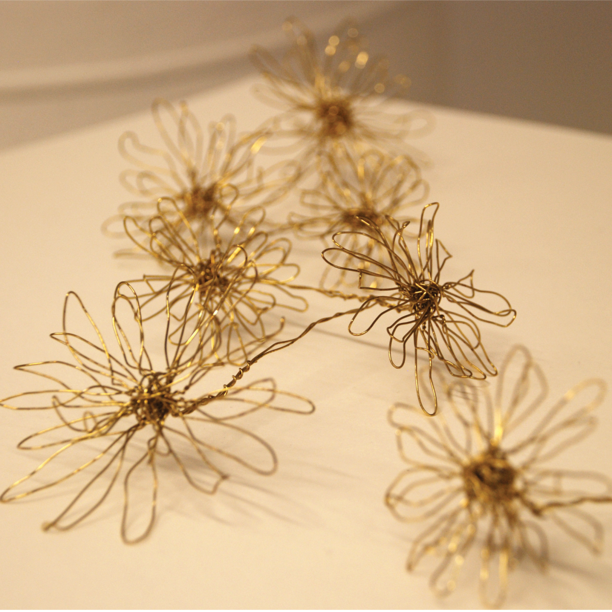 For small hands. Eight piece wire sculpture, gold fine silver plated craft wire