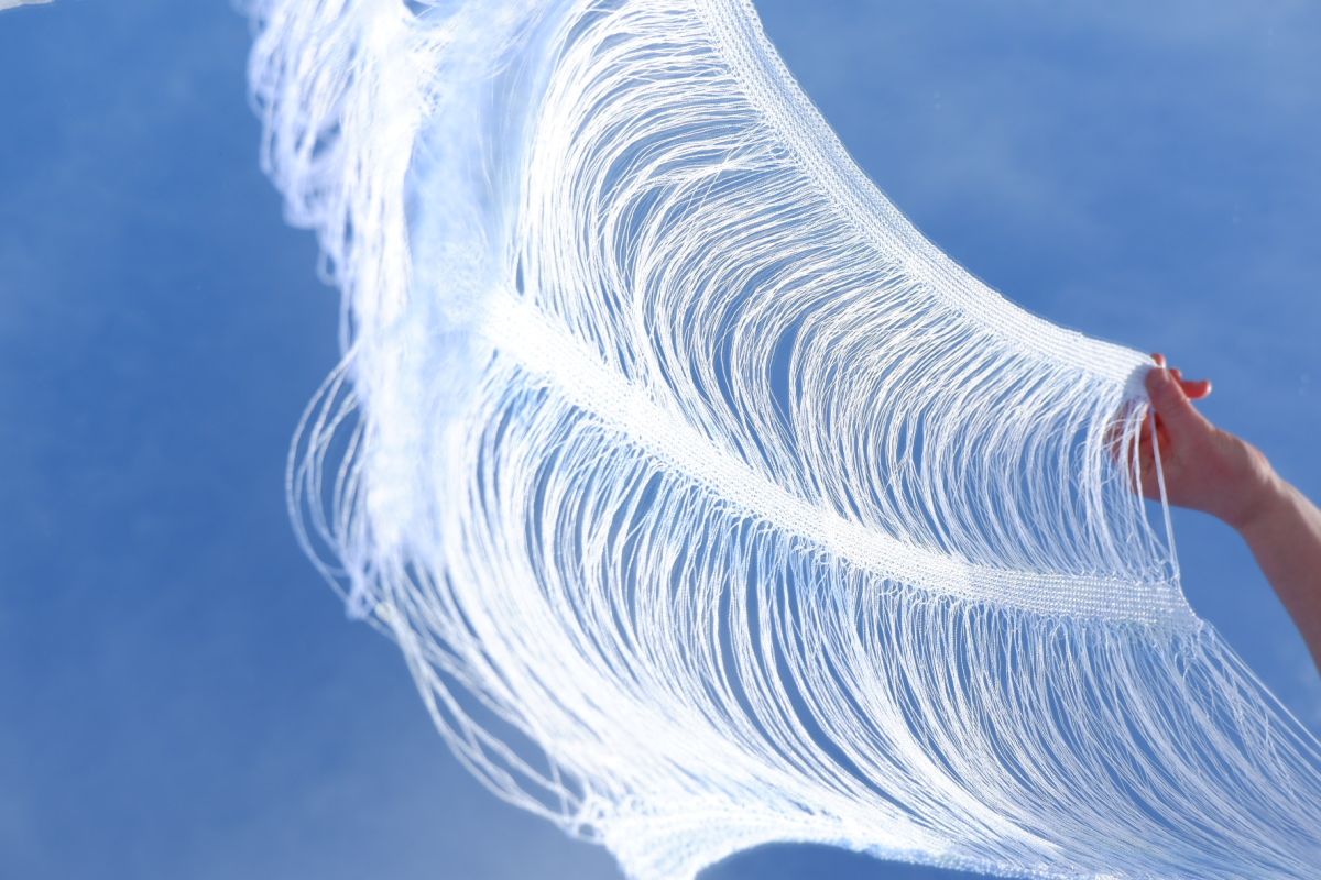 Cirrostratus Cloud Association. Double ended yarn with floats knitted on a double bed machine